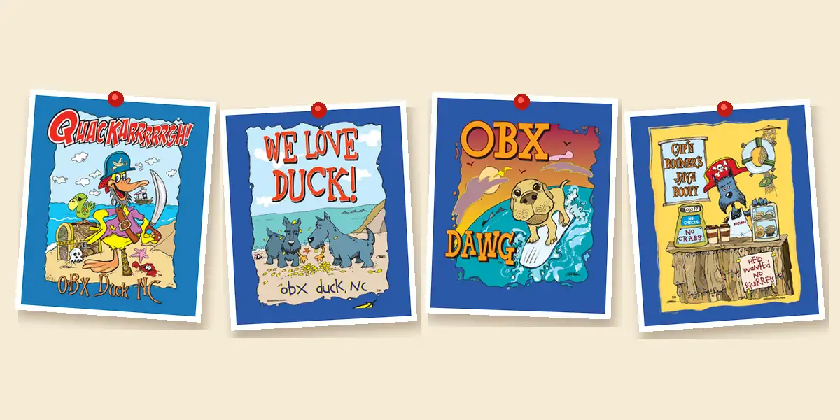 The Quackarrrgh pirate duck, two Scotties under We Love Duck, the surfing OBX Dawg and a pirate coffee shack pinned up on a cream board