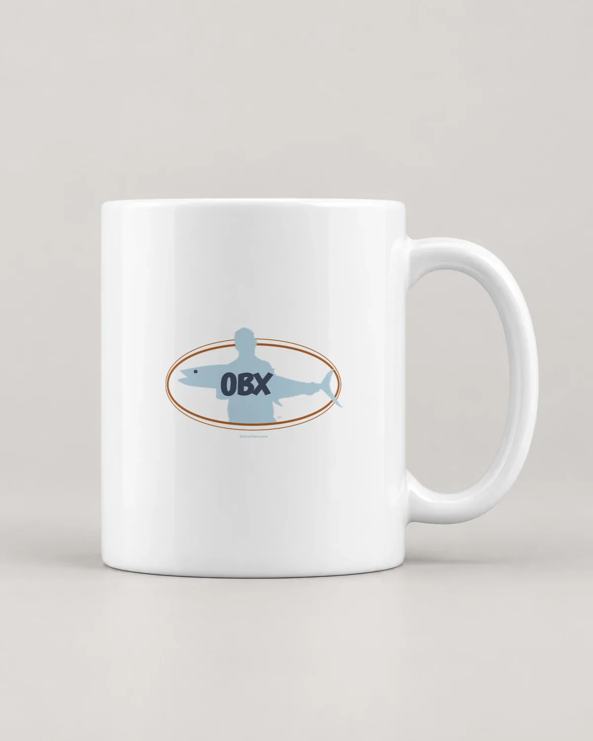 OBX Fish Oval tee on a ceramic mug