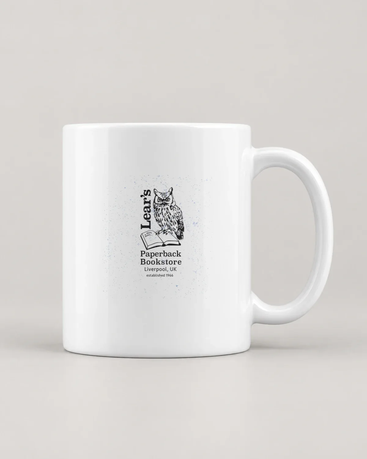 Owl's Paperback Bookstore tee on a ceramic mug