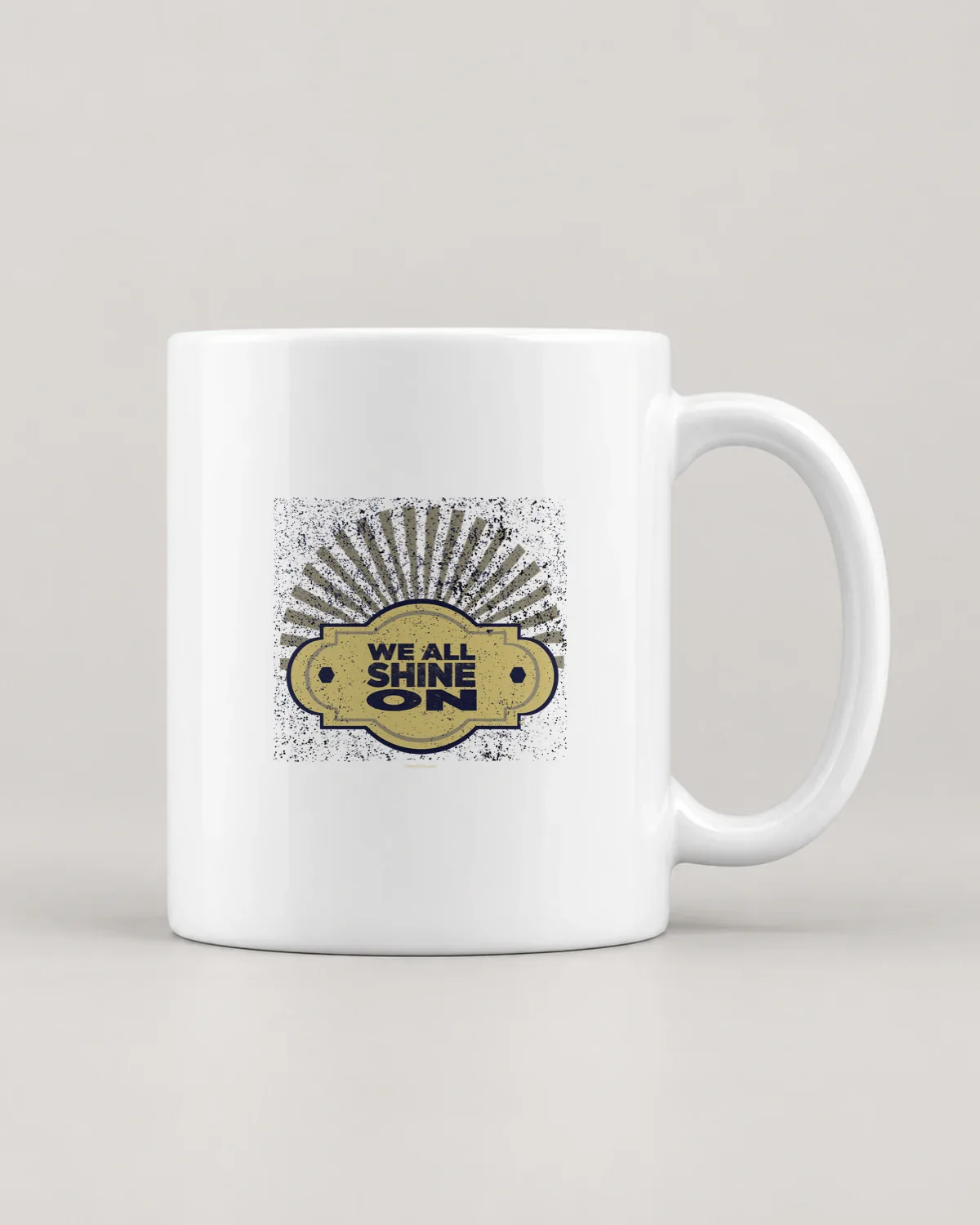 We All Shine On tee on a ceramic mug
