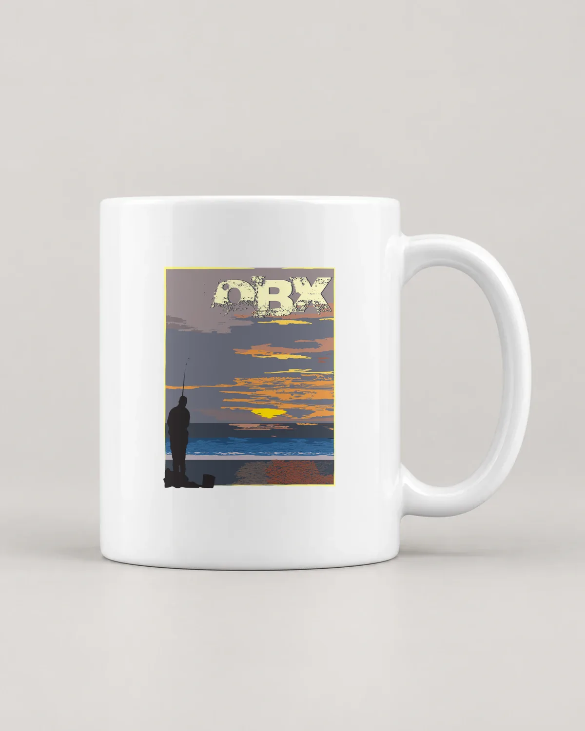OBX Sunrise Fishing tee on a ceramic mug