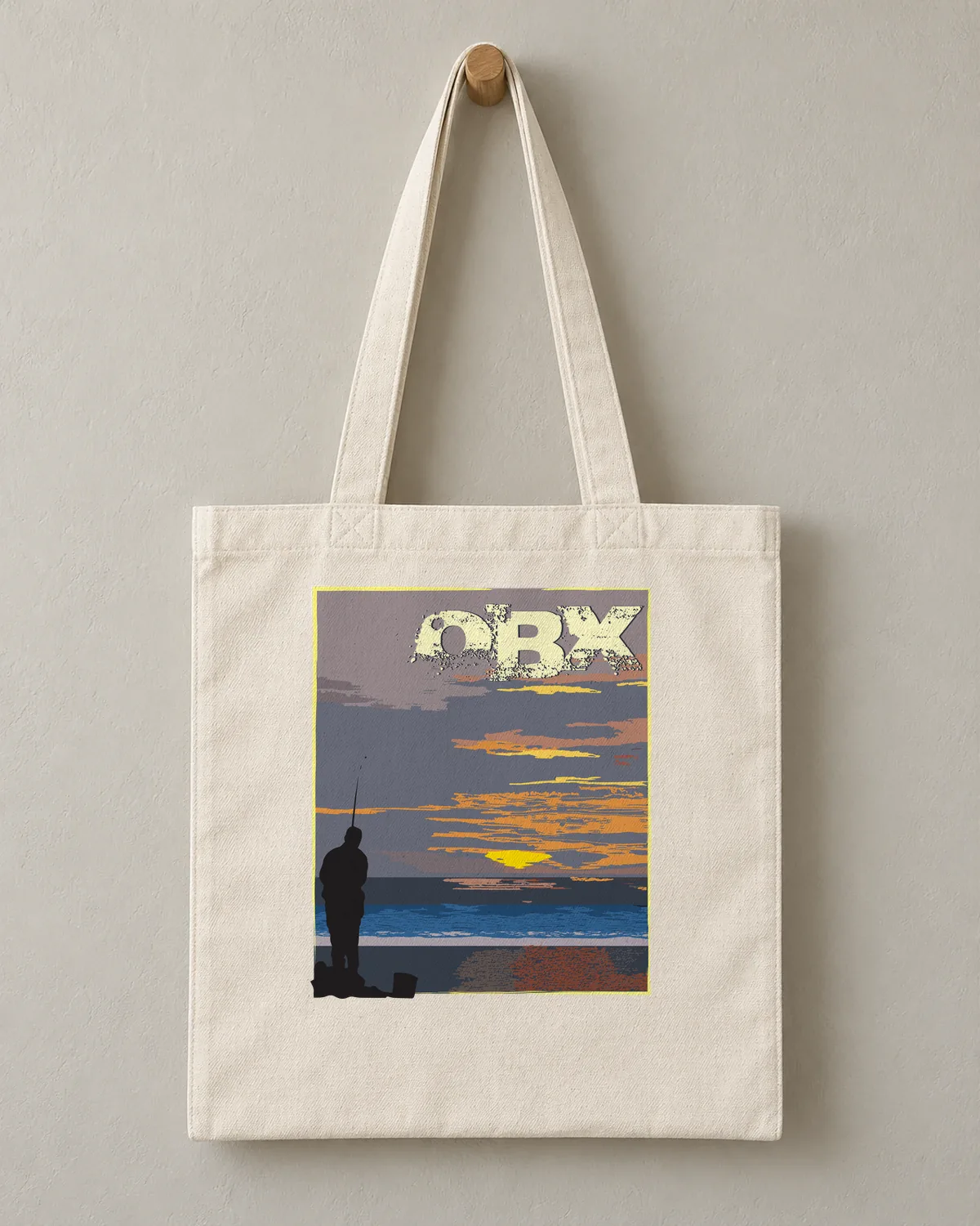 OBX Sunrise Fishing tee on a cotton tote